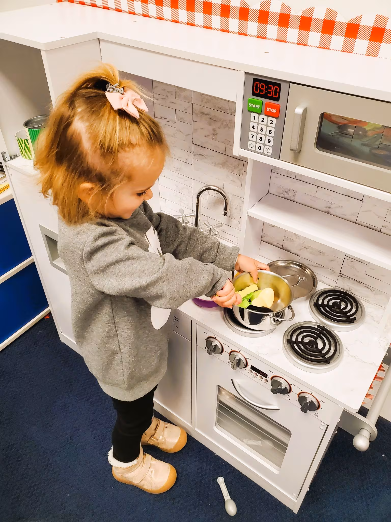 A child proudly completing a task independently at Building Blocks Preschool
